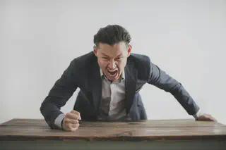 Man with Fist on Table