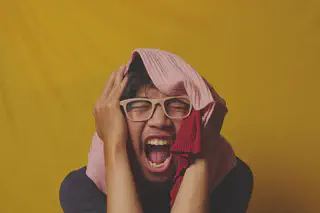 Man Yelling With Towel Over Head