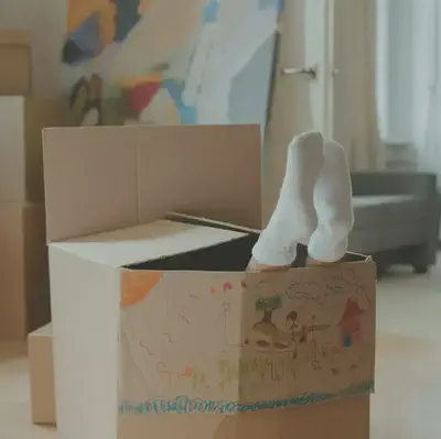 Feet Out of Cardboard Box