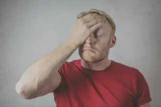 Man Covering Face