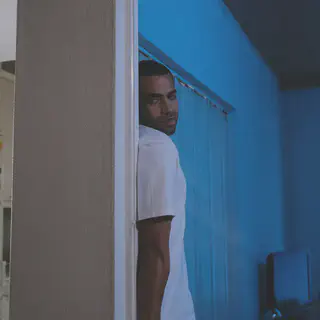 Man Hiding Behind Wall